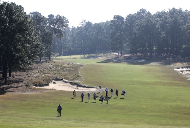 Players walk the 4th hole during a practice round. (USATSI)